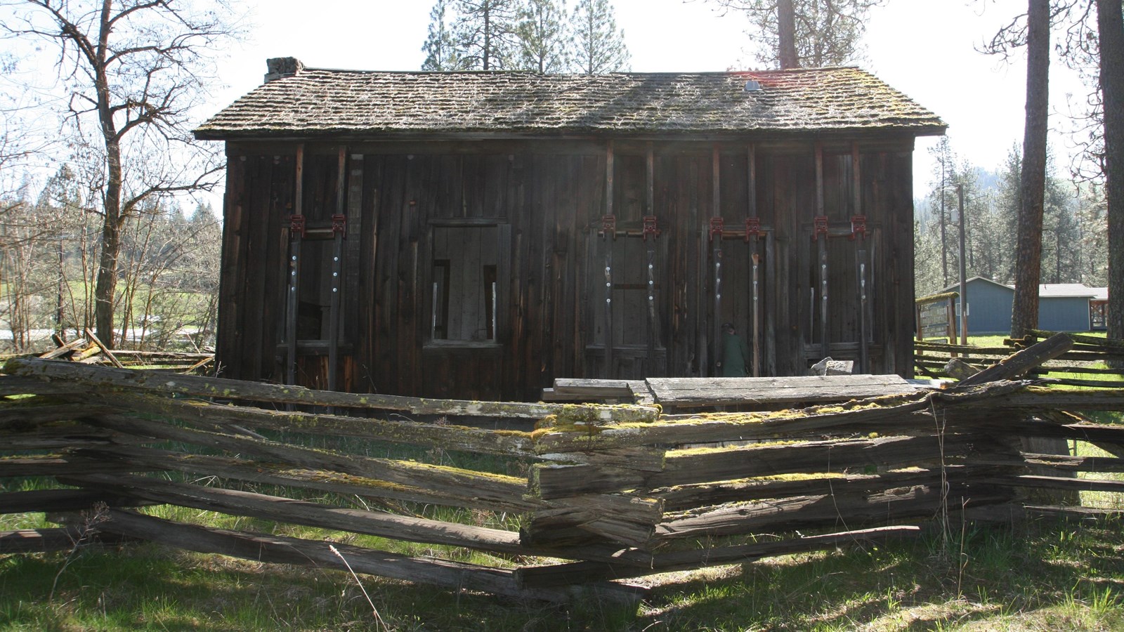 Wooden cabin with a wooden serpentine fence