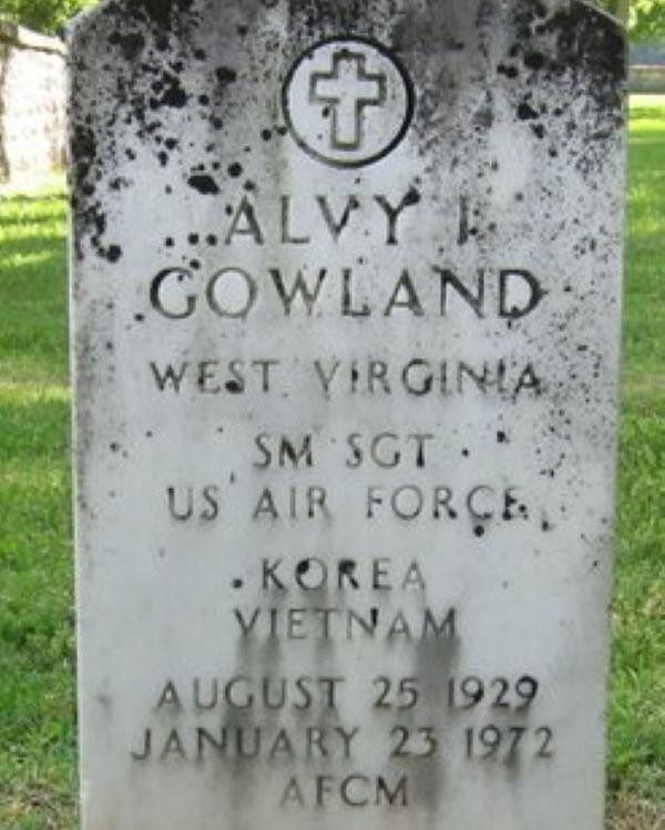 Large marble headstone with a cross centered at the top belonging to Alvy Gowland. 