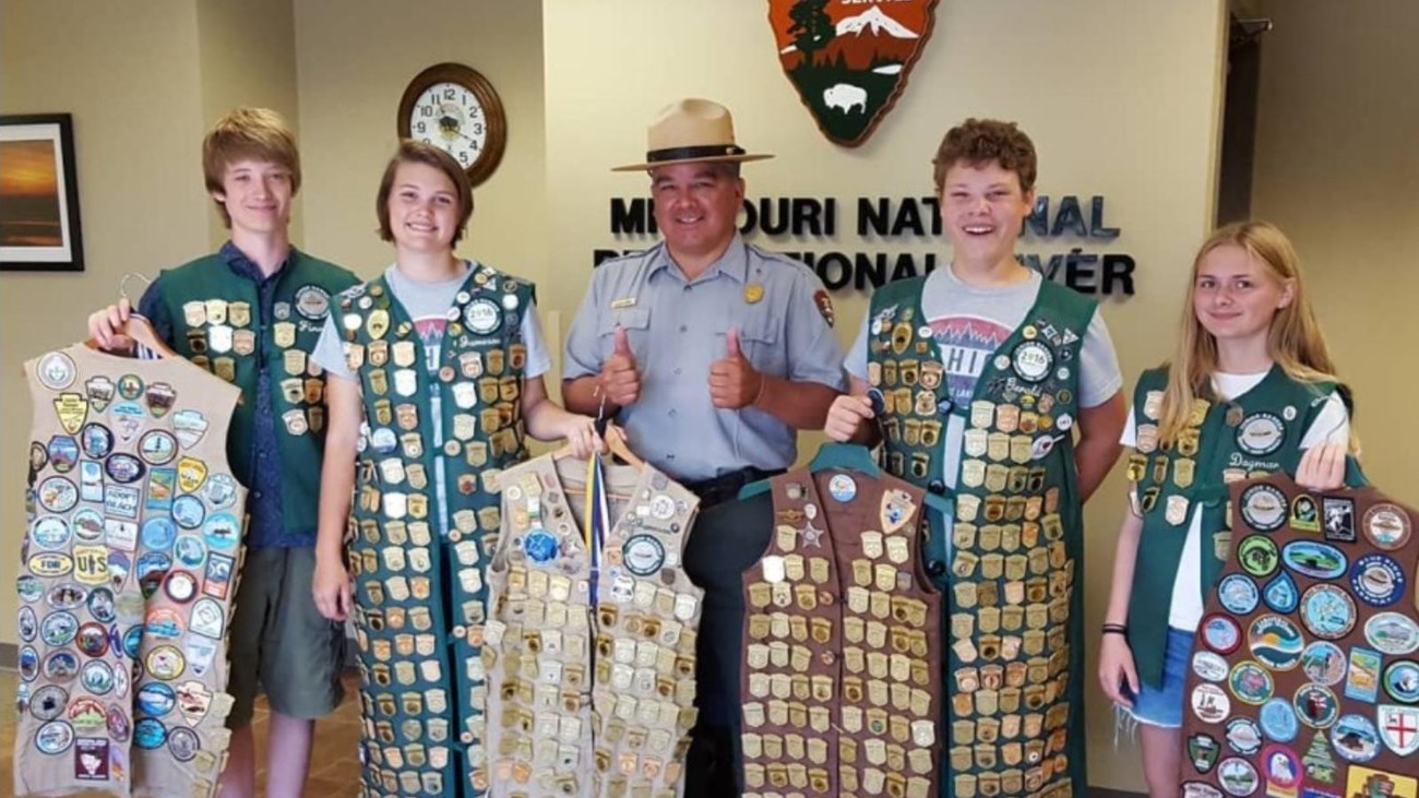 Four junior rangers with the vests and badges.