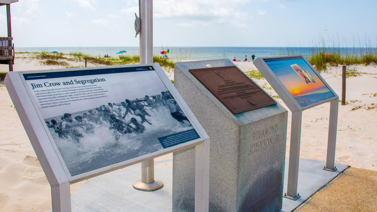 Three waysides for a fallen soldier stand as a memorial on the beach.