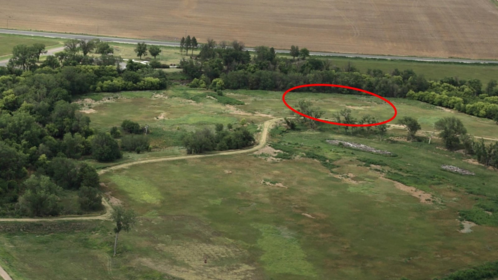 Aerial view of oxbow with area of Quartermaster stables marked with a red circle.