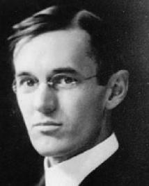 Man in suit and glasses poses for picture