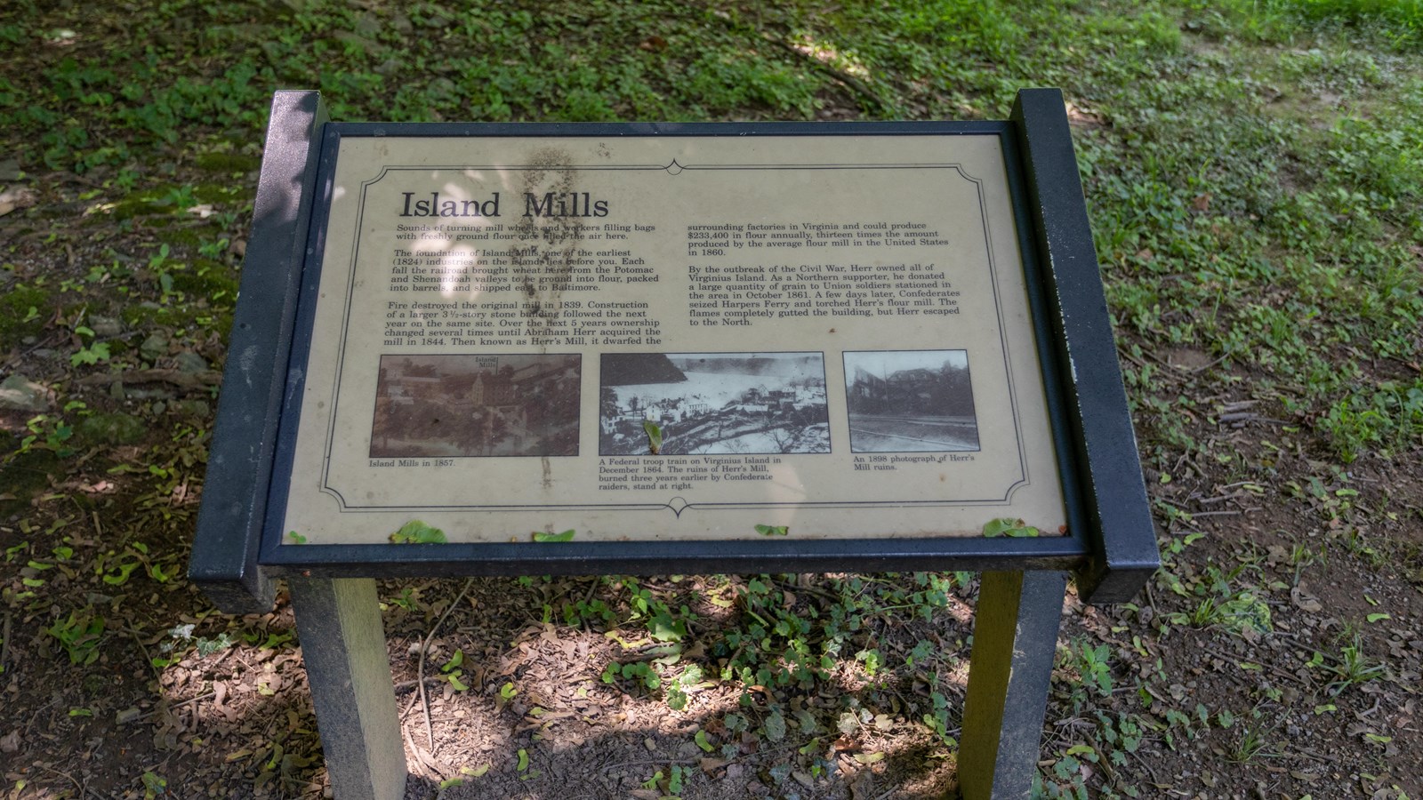 Information panel with historic photos of buildings in lower Harpers Ferry.
