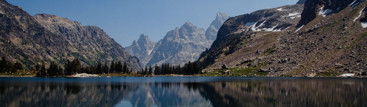 The Grand Teton and Mount Owen reflected on a calm lake.