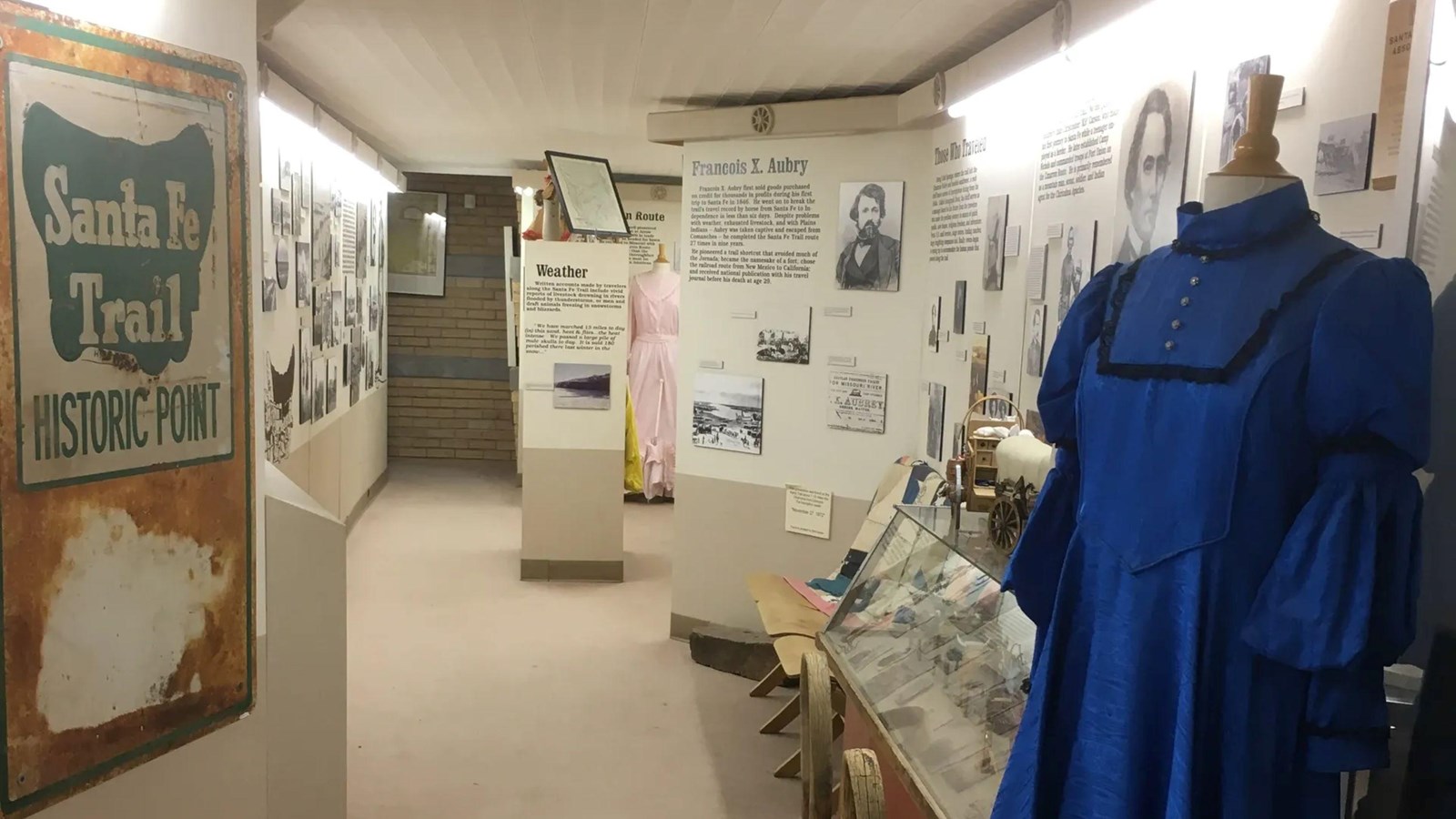 Signed exhibits and historic clothing within a museum.