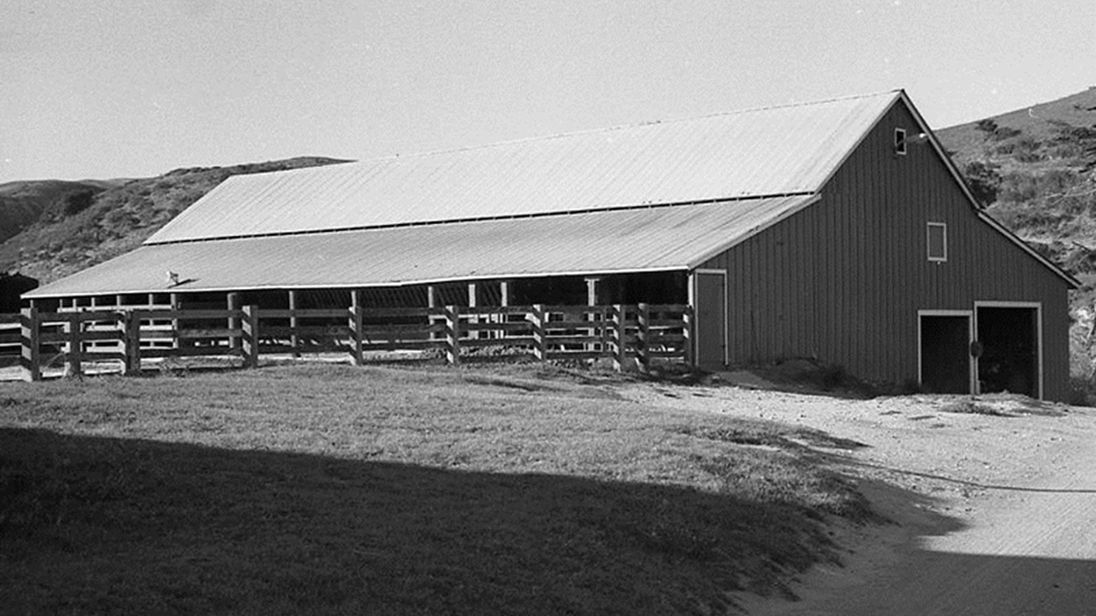 Wood barn with steep roof. 