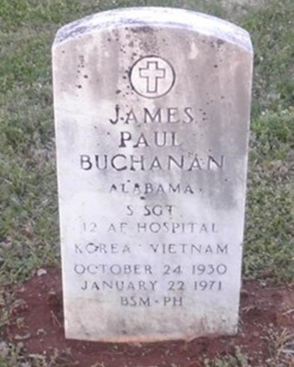 Large marble headstone belonging to James Buchanan with a cross at the top. 