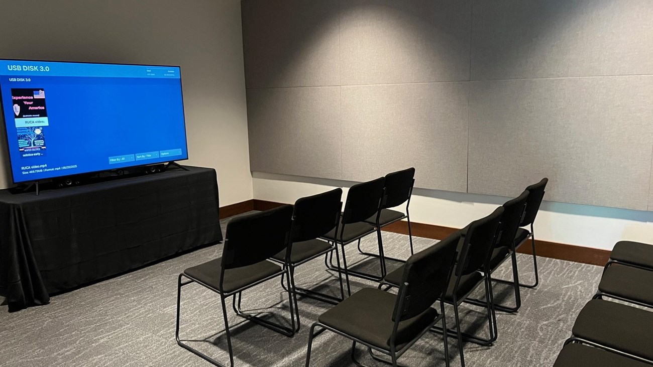 tv screen with black chairs