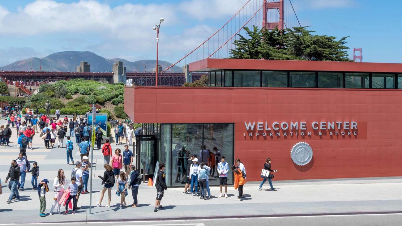 The red brick welcome center, surrounded by visitors at the Golden Gate Bridge
