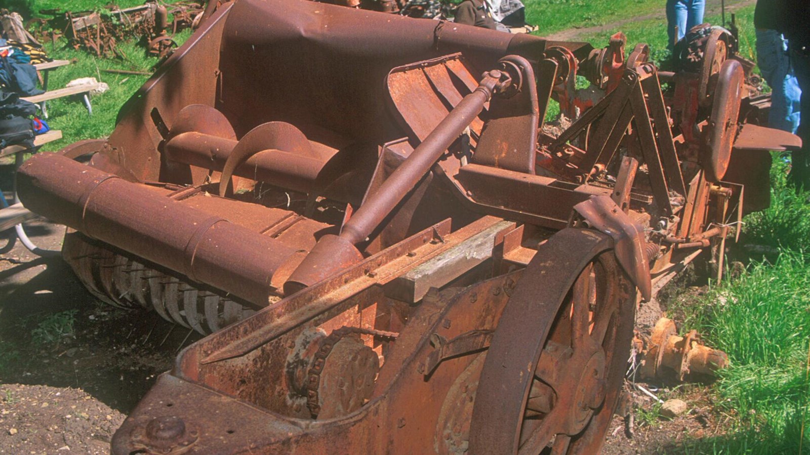 This piece of equipment was pulled by a tractor. A horizontal auger turns a long disc like rake that