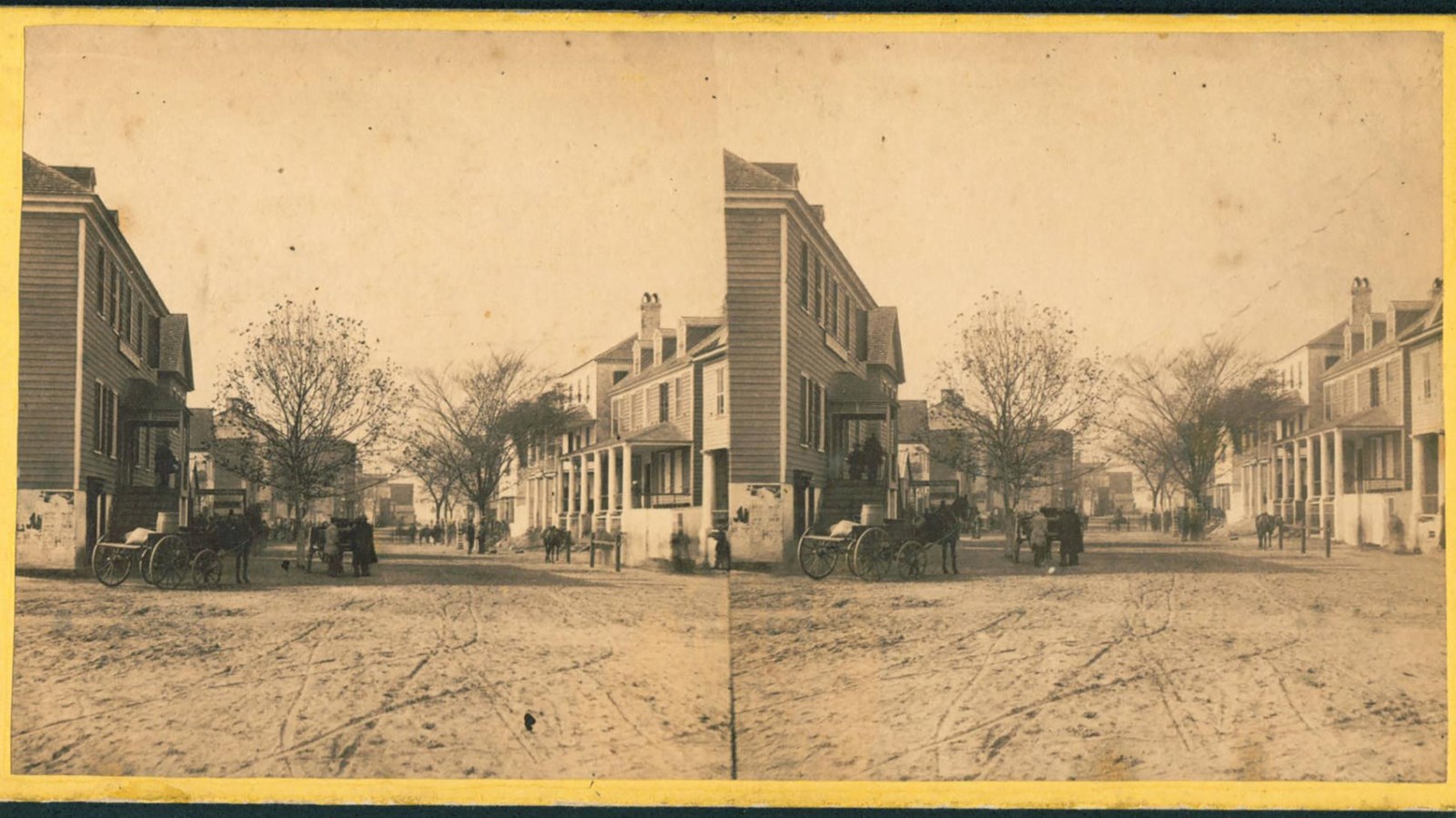 A double view of a historic image of a dirt street with buildings lining either side.