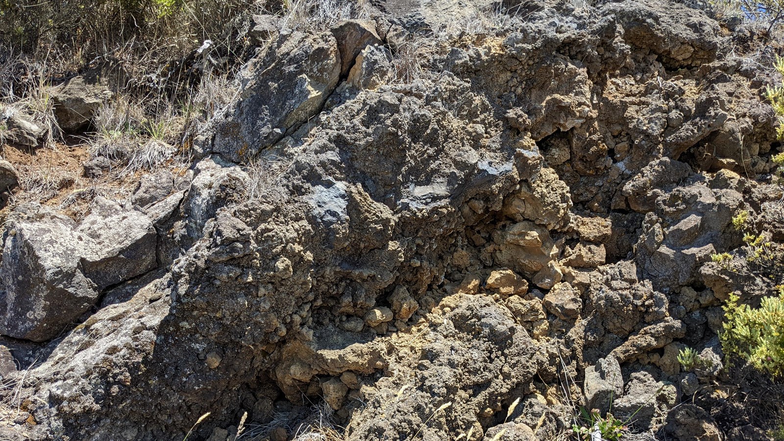 a rough jagged rocky surface with dark and light coloring at an angle