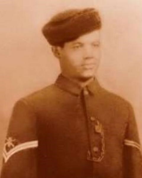 Sepia color photograph of African American man in military uniform from the 1890s
