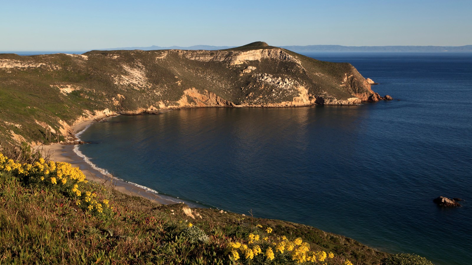 a harbor with steep cliffs surrounding it.