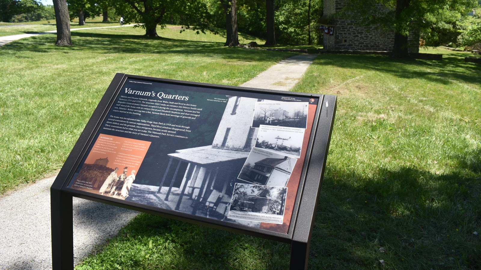 wayside exhibit panel with historic photos of the various restorations