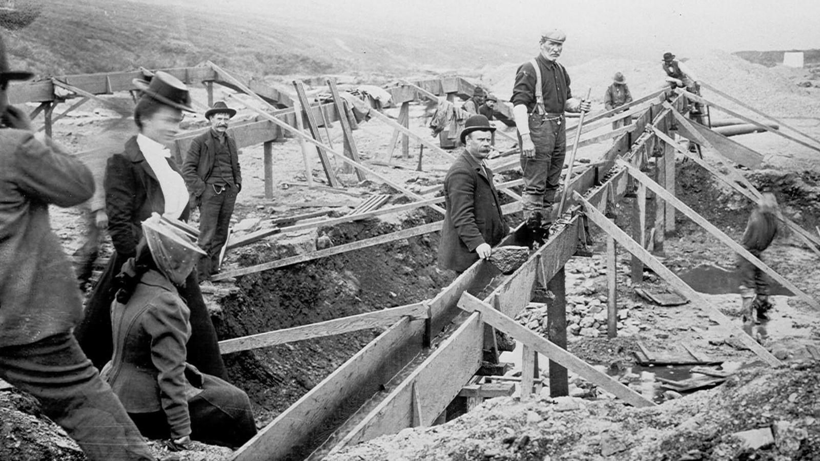 Historic photo of men and women sluicing for gold on the beach circa 1900.