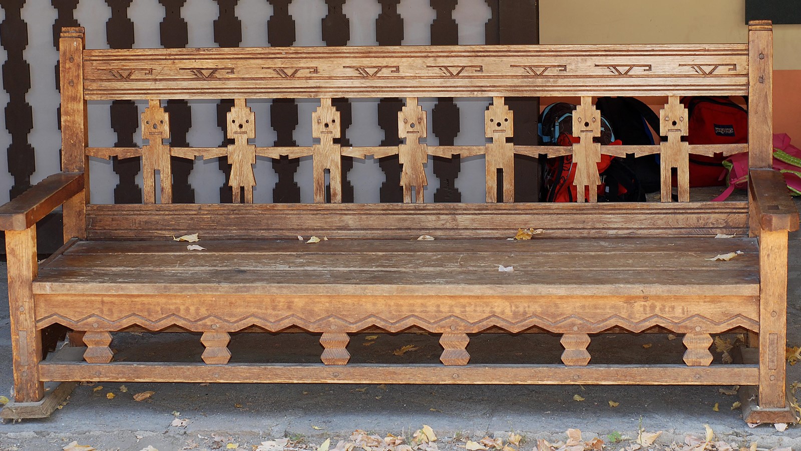 a wooden bench with figures cut out