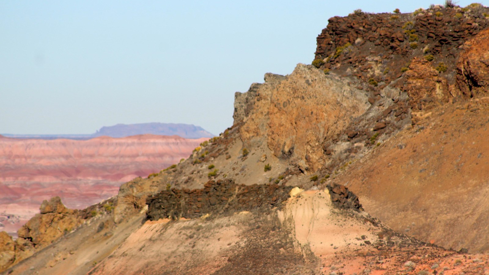 Volcanic escarpment against a blue sky.