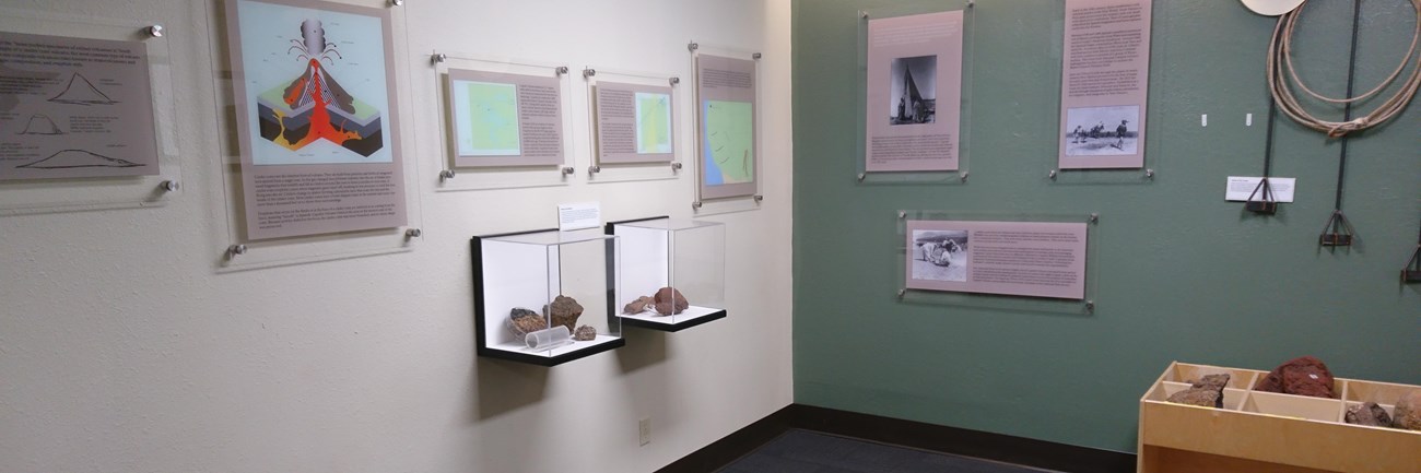 Exhibits in the Visitor Center with a large volcanic bomb on the left and touch table on the right