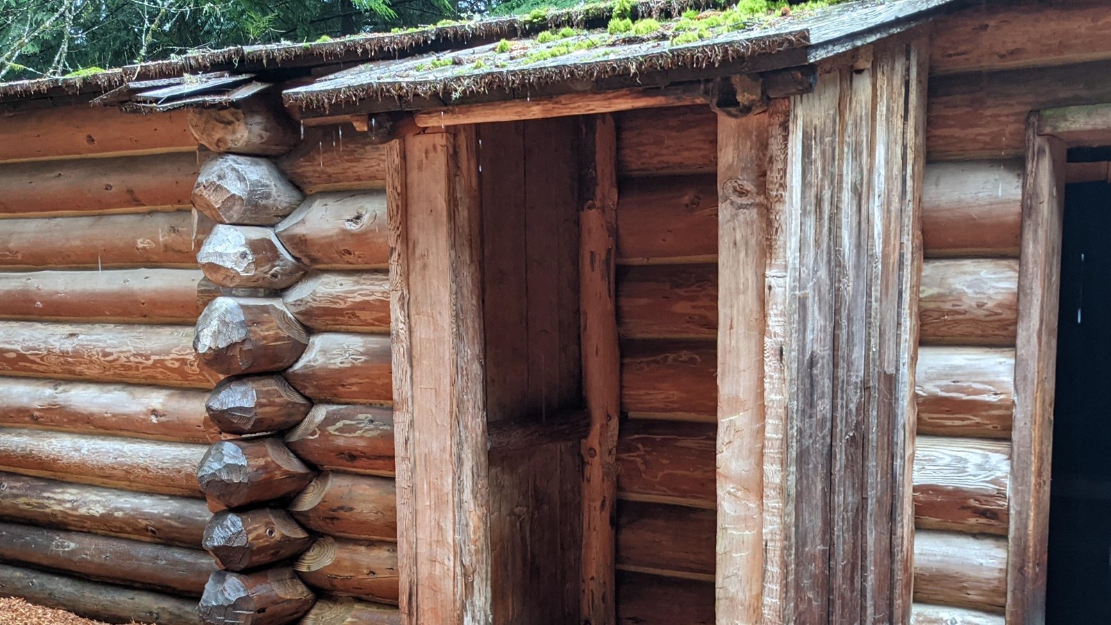 A small wooden shack pressed against the side of Fort Clatop about 6\' tall and 3\' wide.