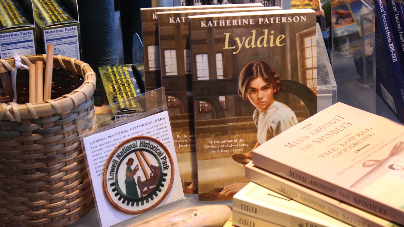 A variety of items, including books and patches, at a gift shop