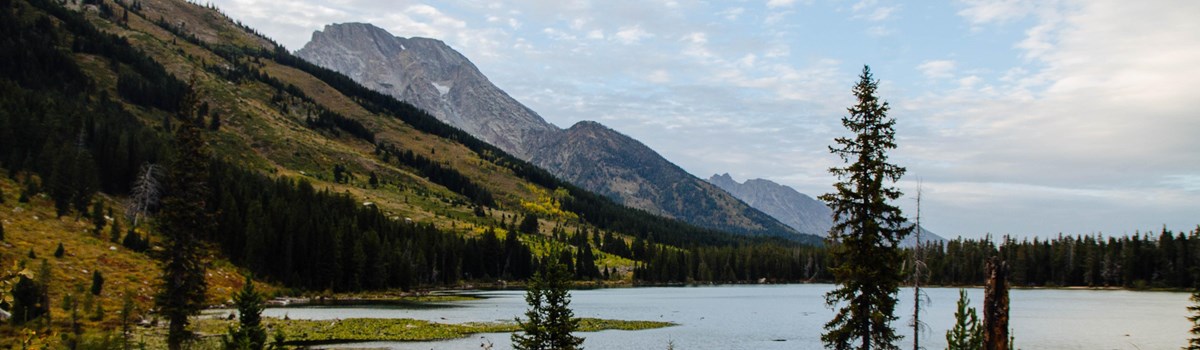 Mountains rise up from a valley lake.