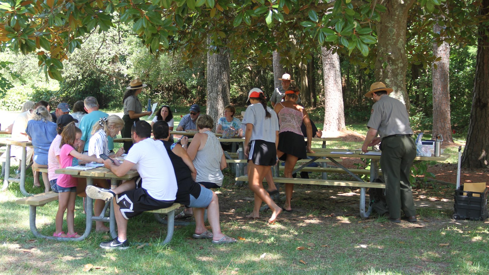 Visitors and rangers at a picnic table