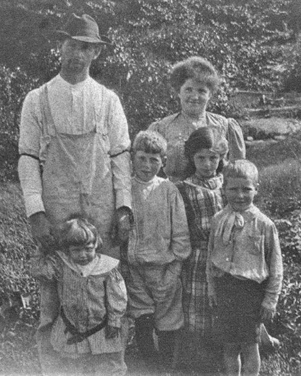 Historic photograph of a family standing in a garden