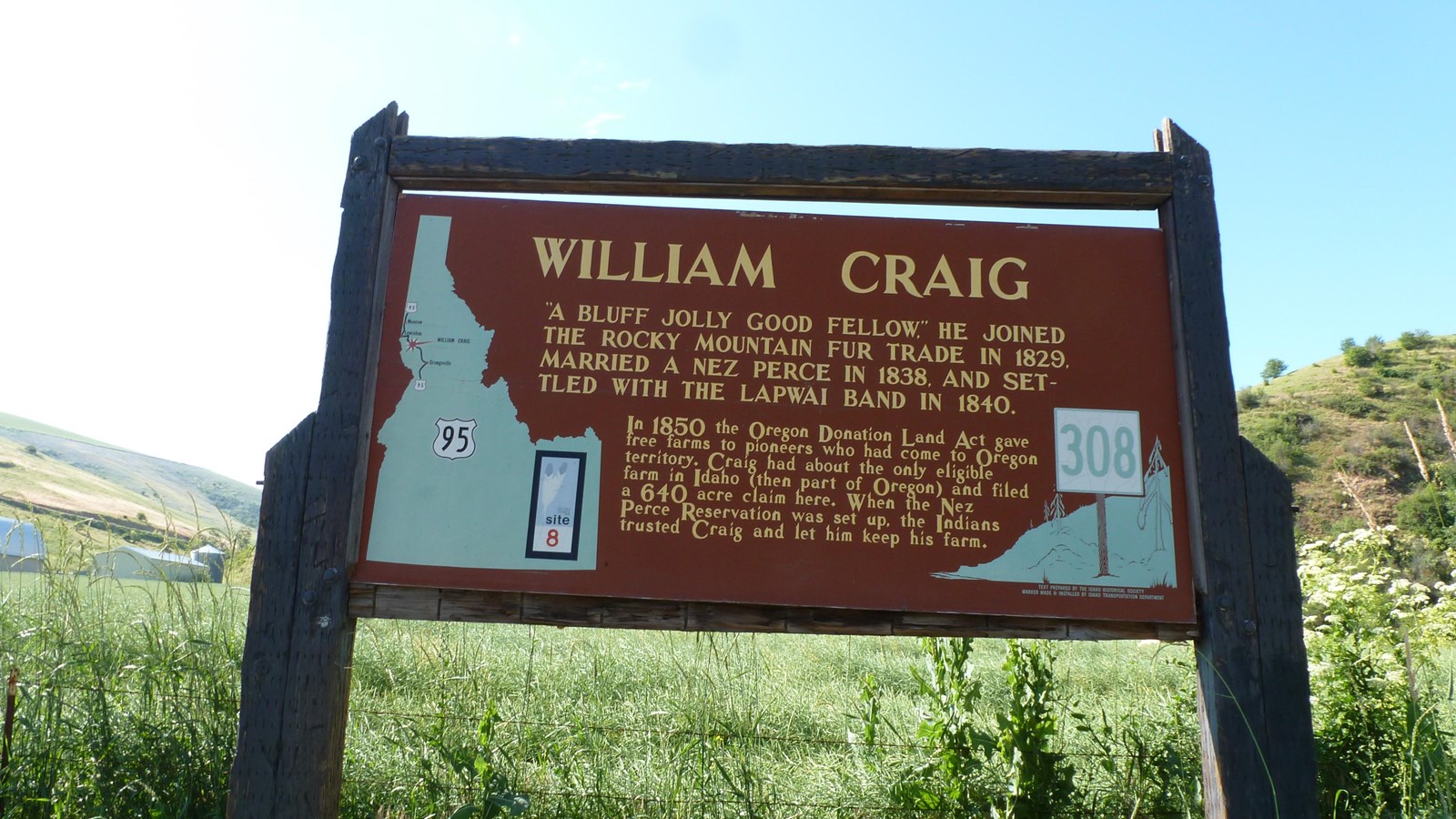 A historical marker sign with wooden beams and written text about William Craig