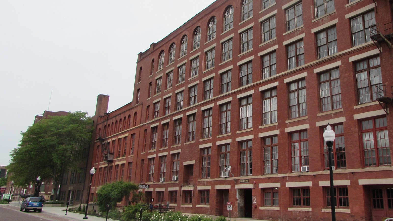 Large brick warehouse and office buildings fronted by brick streets