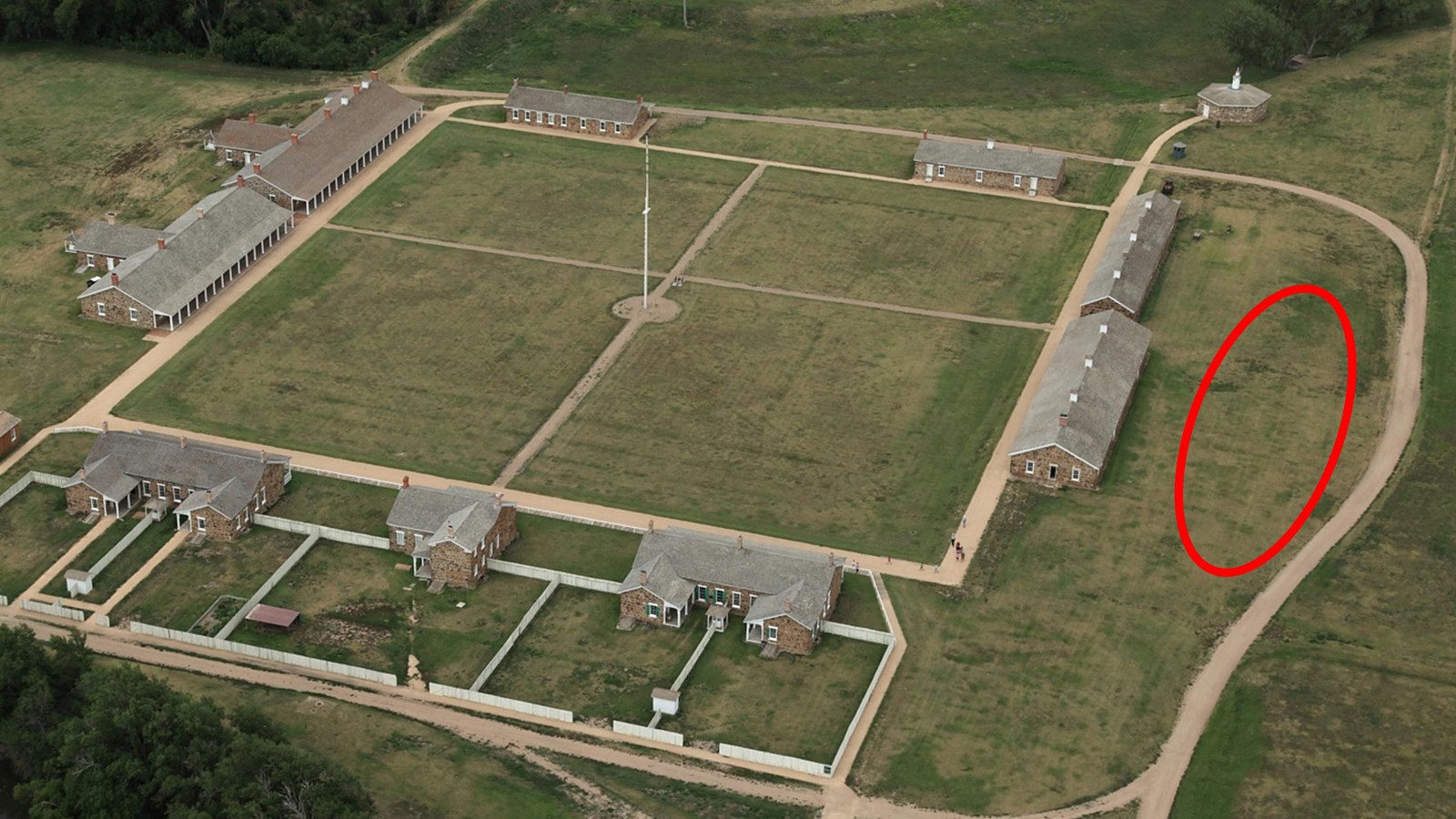 Aerial view of the fort buildings with early officers\' quarters location circled in red.