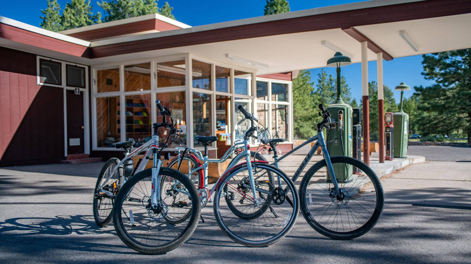 3 bikes in front of a service station