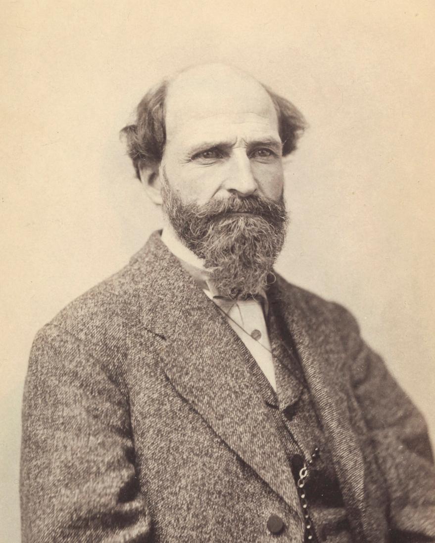 Portrait of man with little hair and a long beard wearing a three piece suit with a grim expression 