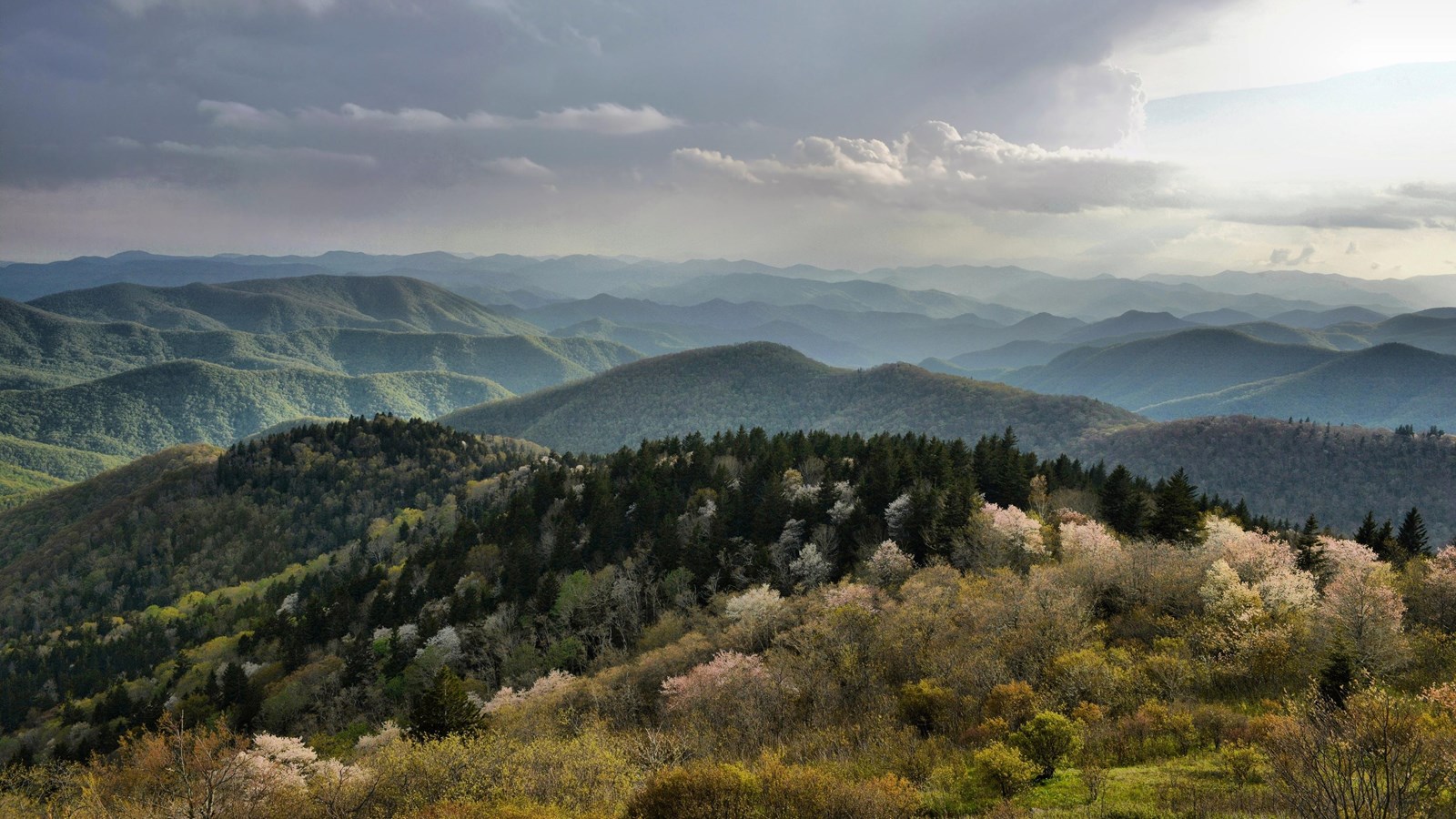 Mountains with sunlight and dark clouds