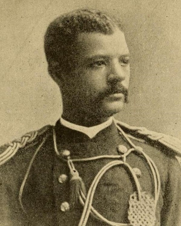 Sepia toned photograph of African American man from the chest up in military uniform of 1880s