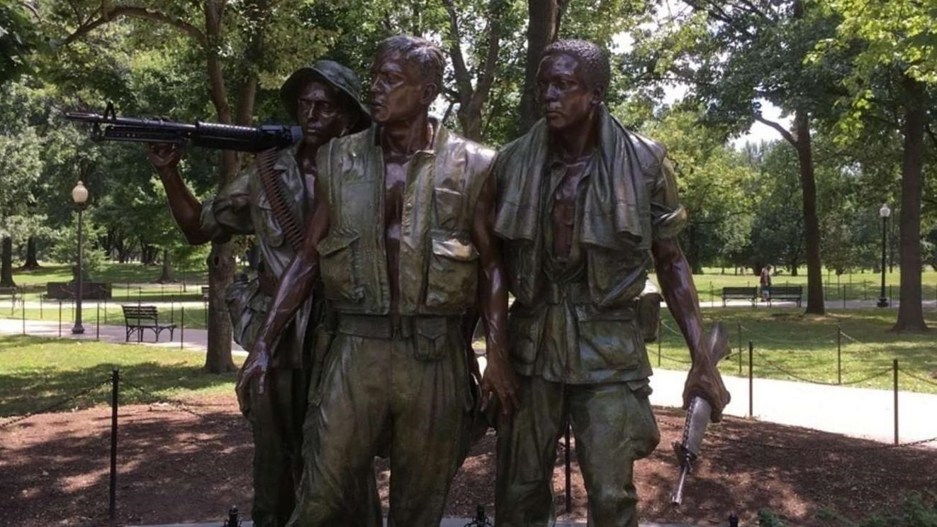 Three statues representing soldiers in Vietnam.