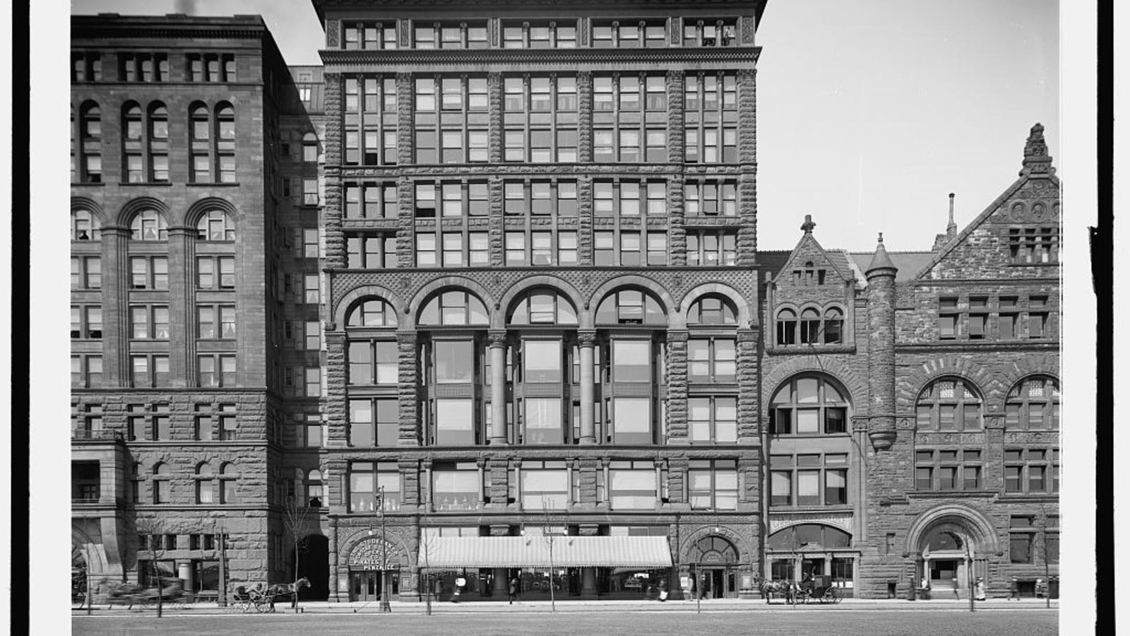A black and white photograph of a ten story brick building built in Richardson Romanesque style.