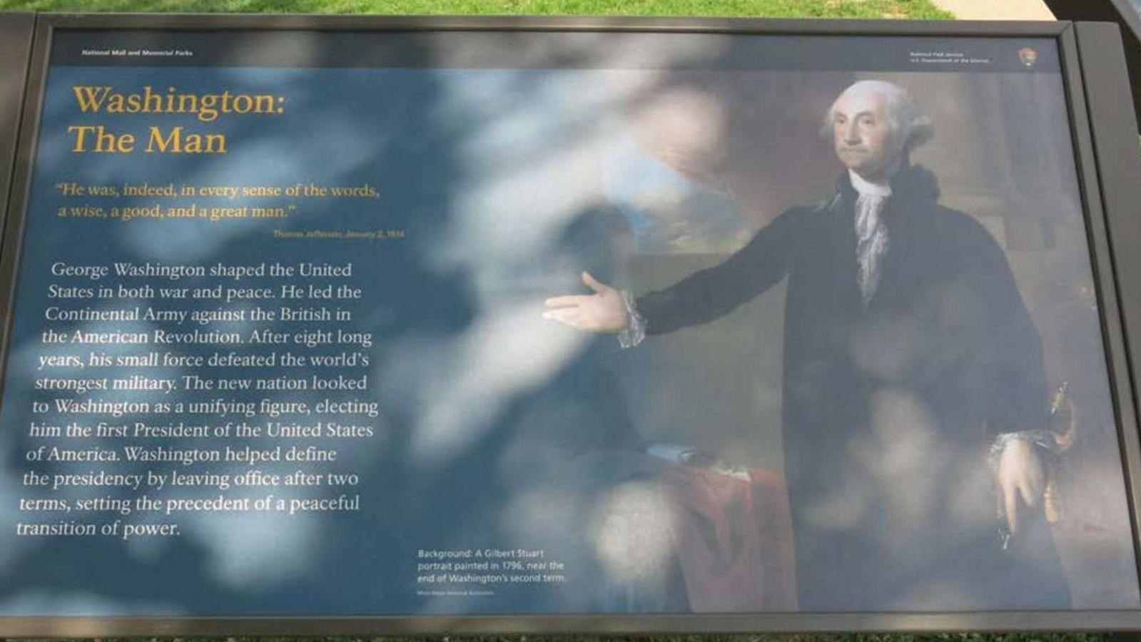 Wayside with painting of a man extending left hand towards text while holding sword in other hand.