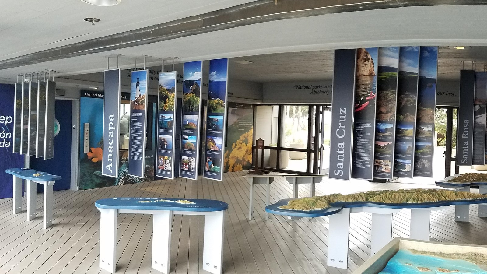 hanging panel with photos over island tactile models.