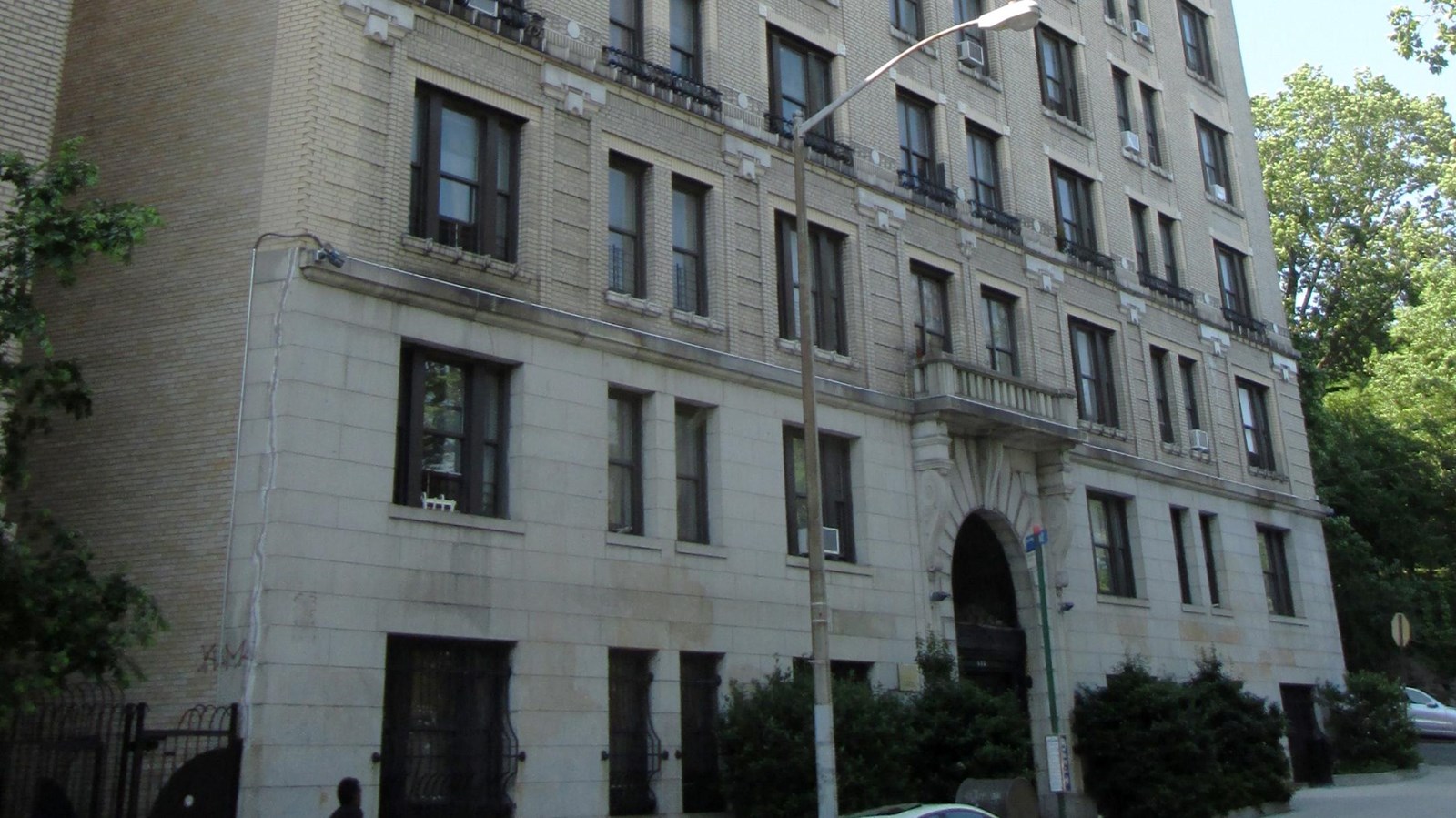 Tall, multi-story stone apartment complex. 