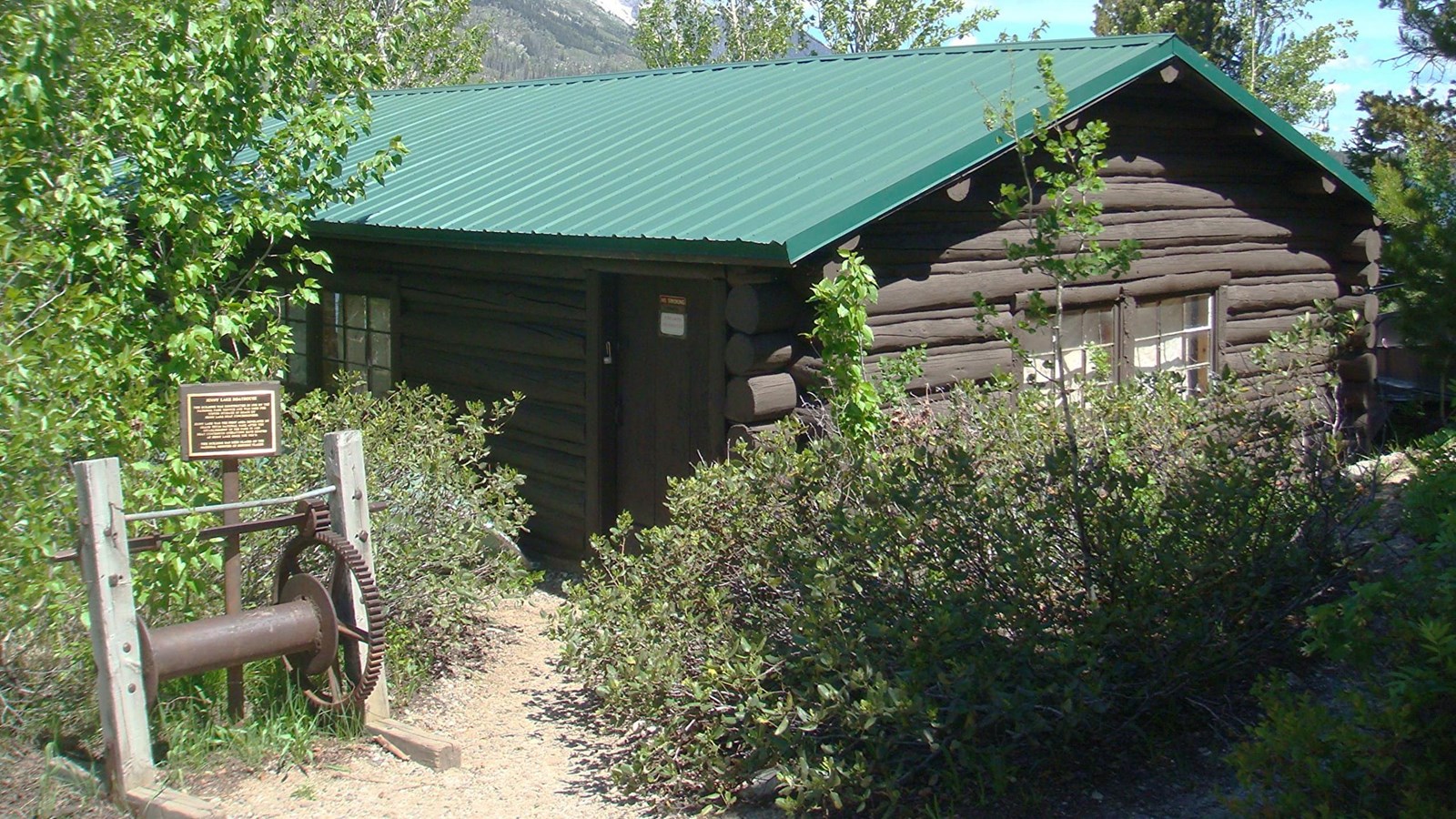 The back side of the Charles Wort Boathouse and a sign noting its significance. 