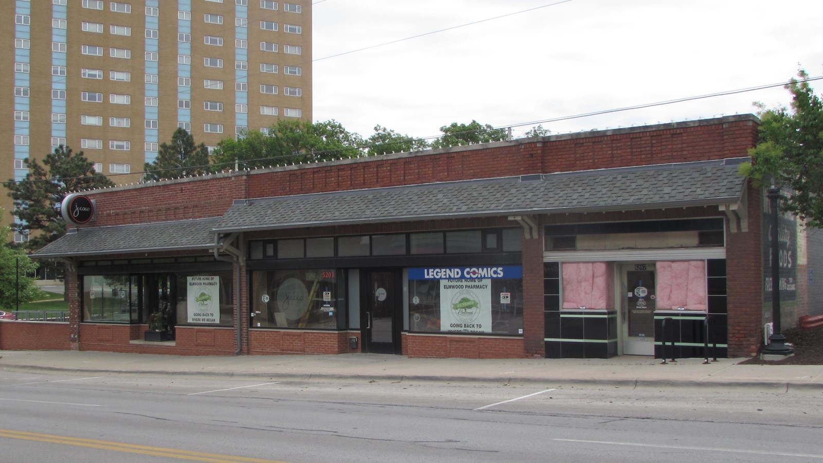 Three bay commercial building. One-story, brick, with shingled awning across front.