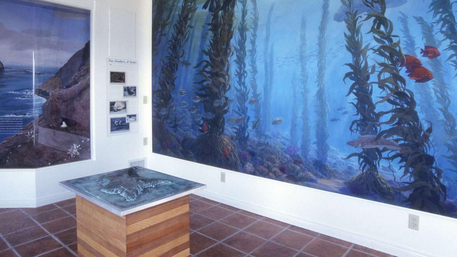 Image of the interior of the visitor center showing a mural, diorama, and relief map.