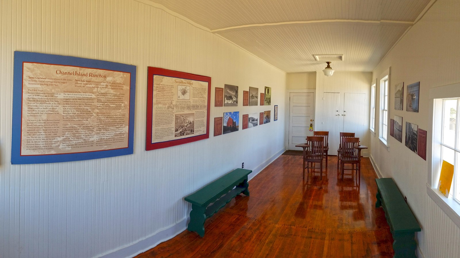 old schoolhouse room with wood floors and signs on walls with wood desks