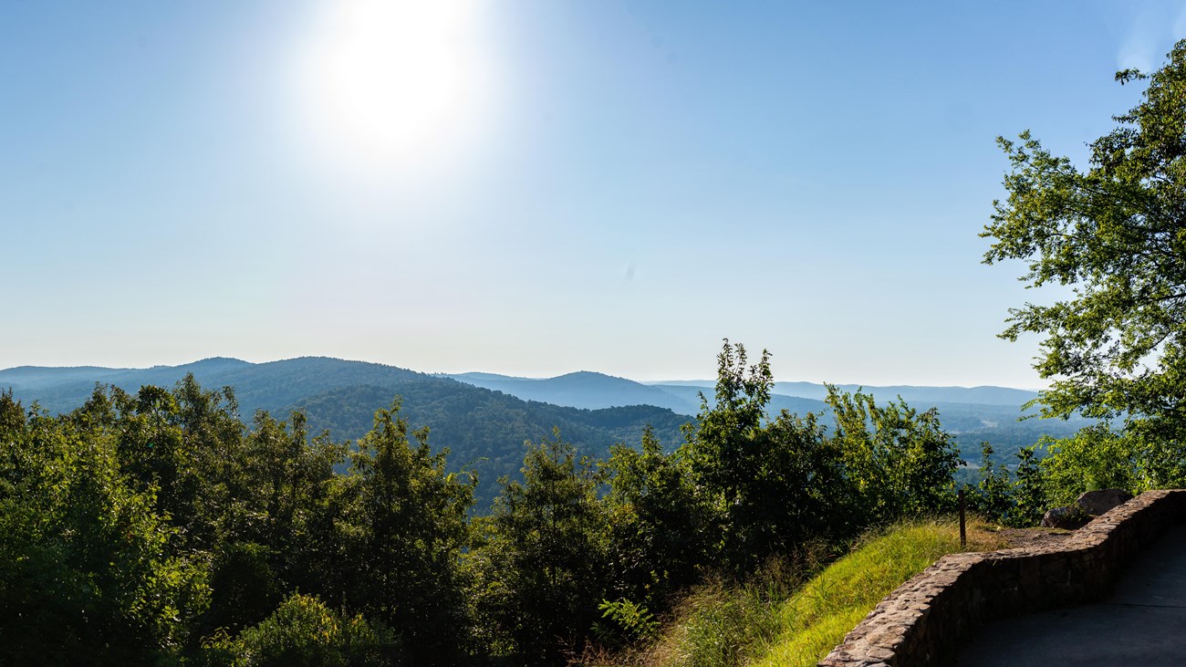 Rolling hills and forested hillsides extend towards the horizon.