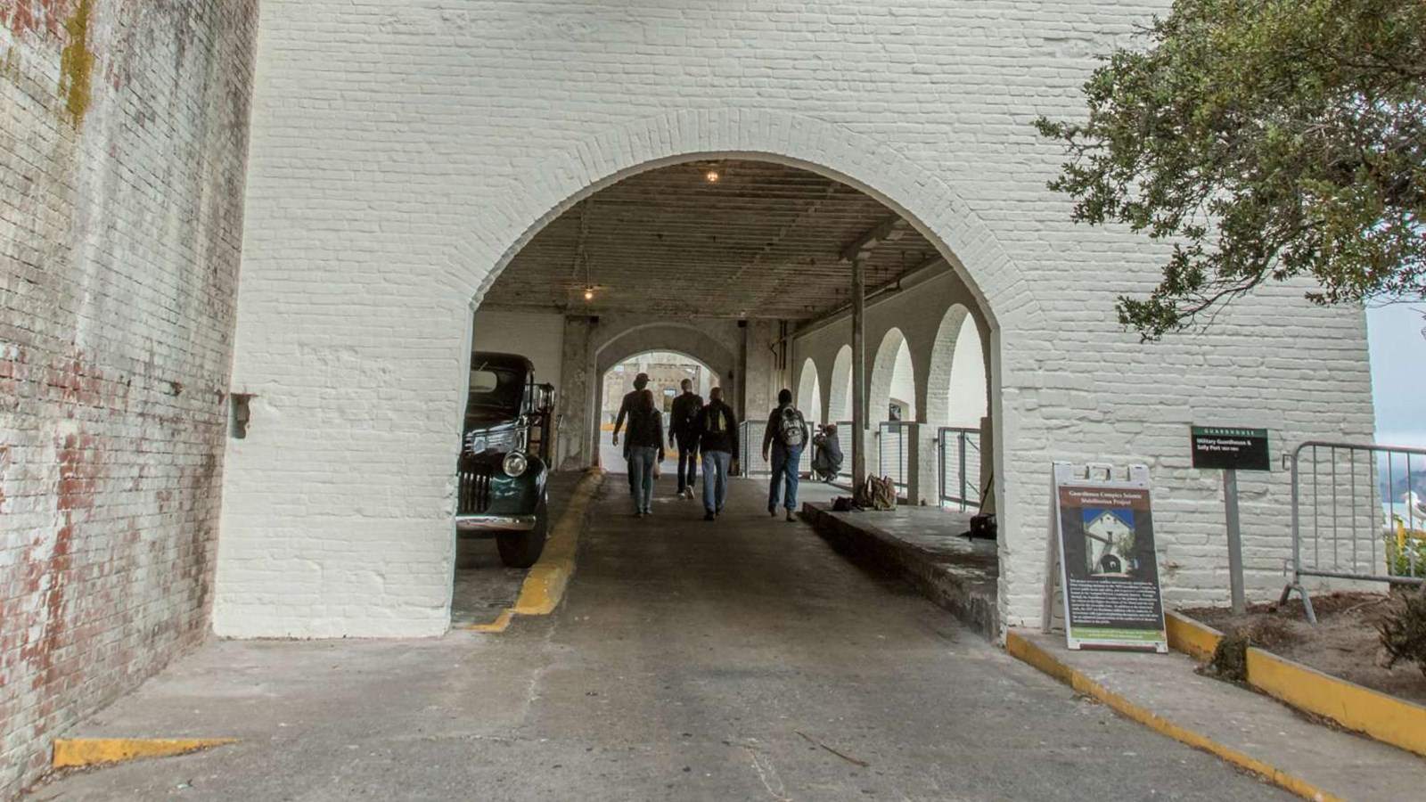 The tall sally port gatehouse building and rounded entrance from the road.