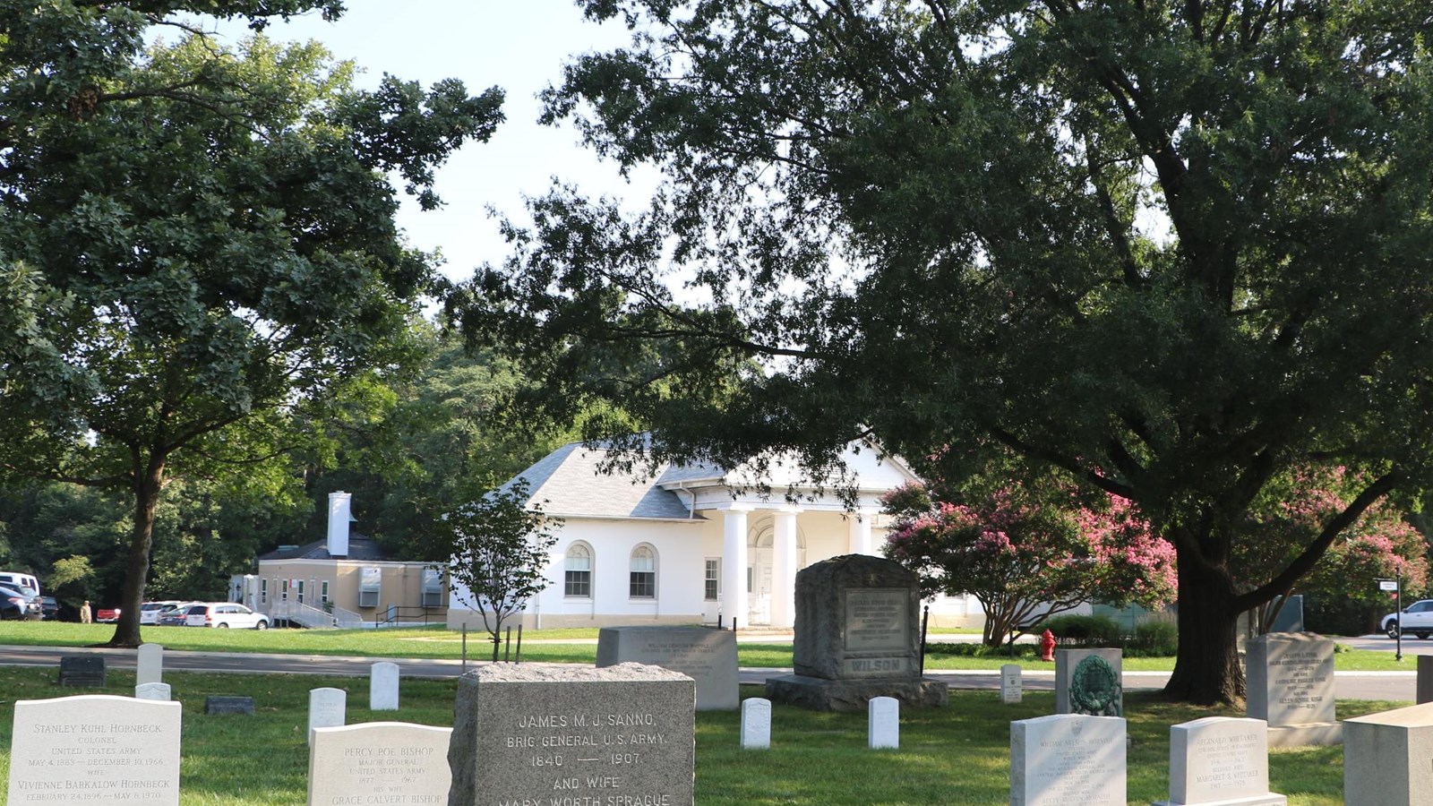 A white building in a cemetery.