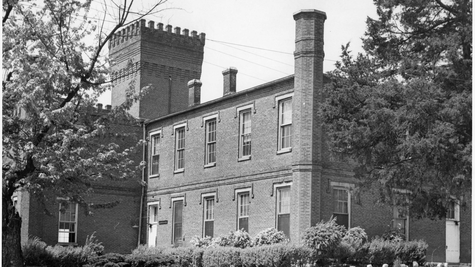 Two story brick building with tower