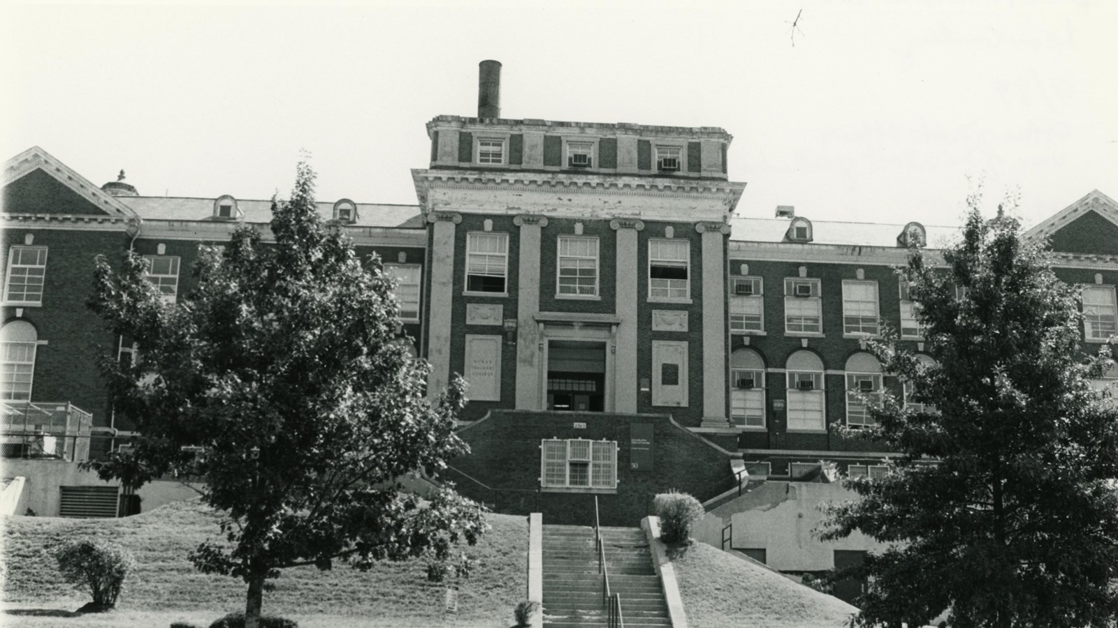 Large brick school building on a hill