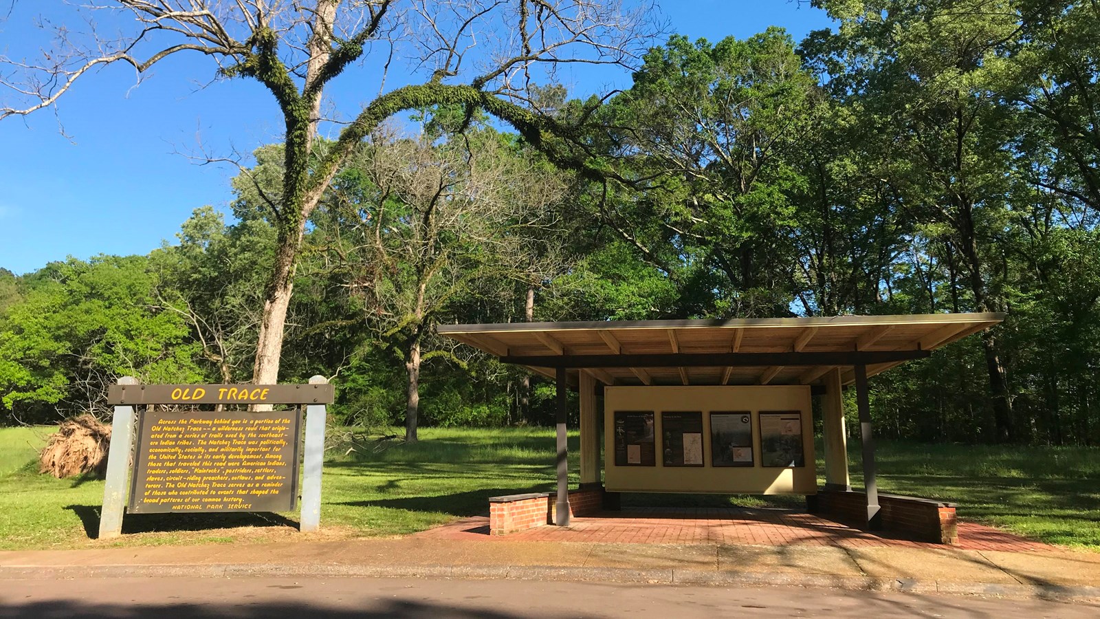 A courted sign and a small shelter with exhibit panels. 